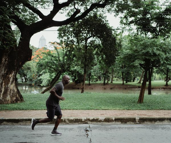 Man focused during a floor exercise, showing concentration and determination.